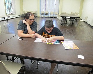 Neighbors | Natalie Wright.Andrea and Nicholas McGooan worked together on a Paint By Sticker picture of The Beatles. They said that they attended about four events for the Summer Reading Program so far and have plans to attend more before the event is completed for the year.