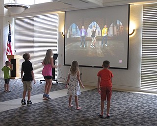 Neighbors | Jessica Harker.Children dance along with a Kids Bop dance video played at the Gotta Move 2.0 event at the Austintown library.