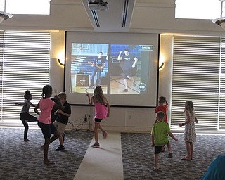 Neighbors | Jessica Harker.Children dance along with a work out video played at the Gotta Move 2.0 event at the Austintown library on July 27.