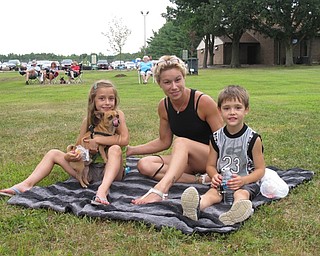 Neighbors | Jessica Harker.Mary Mattesyn and two of her children, Matteson and James Campbell, listened to the YACCB play on July 24 at Austintown Park.