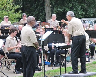 Neighbors | Jessica Harker.Director Joe Pellergrini led the Youngstown Area Community Concert Band as a member of the band does a voice over portion for one of the compositions preformed by the band on June 24 at the Austintown Park.