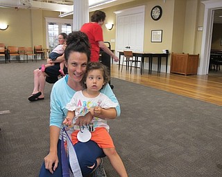 Neighbors | Natalie Wright.Luci and Katie DePalma made a rhythm ribbon from a popsicle stick and colorful streamers at the Poland library on July 23.