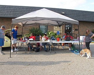 Neighbors | Jessica Harker.Members of the MVOCC sat at the table outside of the Austintown Senior Center where they ran a 50/50 raffle and collected entrance fees for the weekly Cruise Night.