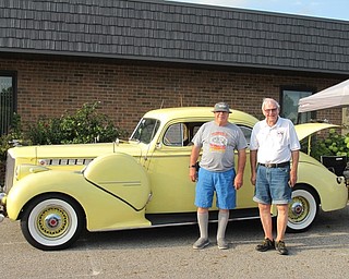 Neighbors | Jessica Harker.Rich Posivak (right), a MVOCC member, posed next to his car with a Cruise Night attendee on Aug. 7 outside of the Austintown Senior Center.