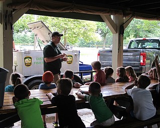 Neighbors | Jessica Harker.Volunteers from the ODNR division of wildlife held live fish for the children to see and determine the species during Adventure Camp in Boardman Park.