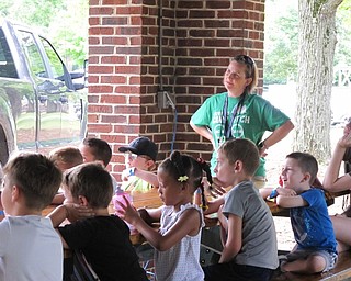 Neighbors | Jessica Harker.Campers in the kindergarten through first-grade age group along with camp director Karen McCallum listened to the ODNR division of wildlife's presentation in Boardman Park on Aug. 7.