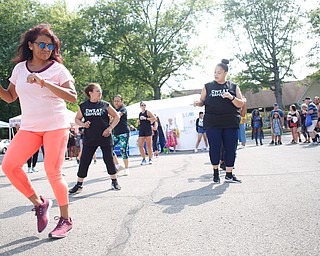 Aida Quinn, front left, of Hubbard and originally from Panama City, does Zumba with others at the Latino Heritage Festival in Campbell on Saturday. EMILY MATTHEWS | THE VINDICATOR