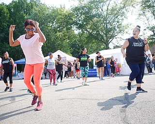 Aida Quinn, front left, of Hubbard and originally from Panama City, does Zumba with others at the Latino Heritage Festival in Campbell on Saturday. EMILY MATTHEWS | THE VINDICATOR