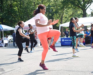 Aida Quinn, front center, of Hubbard and originally from Panama City, does Zumba with others at the Latino Heritage Festival in Campbell on Saturday. EMILY MATTHEWS | THE VINDICATOR