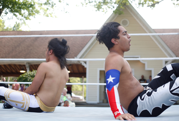 Cree Fudo, left, and Marc-Anthony Alejandro wrestle at the Latino Heritage Festival in Campbell on Saturday. EMILY MATTHEWS | THE VINDICATOR