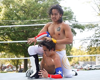 Wrestler Cree Fudo, above, tries to take down his opponent Marc-Anthony Alejandro at the Latino Heritage Festival in Campbell on Saturday. EMILY MATTHEWS | THE VINDICATOR