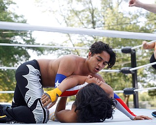 Wrestler Marc-Anthony Alejandro tries to pin down his opponent Cree Fudo at the Latino Heritage Festival in Campbell on Saturday. EMILY MATTHEWS | THE VINDICATOR