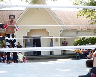 Wrestler Marc-Anthony Alejandro cheers for his teammate Calvin Couture as he wrestles at the Latino Heritage Festival in Campbell on Saturday. EMILY MATTHEWS | THE VINDICATOR