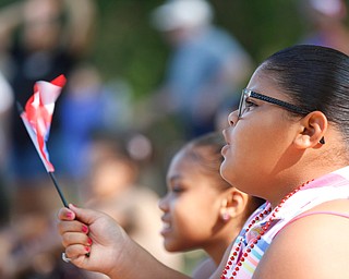 Jodairys Vasquez, 9, of Campbell, waves a Puerto Rican flag while watching wrestling at the Latino Heritage Festival in Campbell on Saturday. EMILY MATTHEWS | THE VINDICATOR