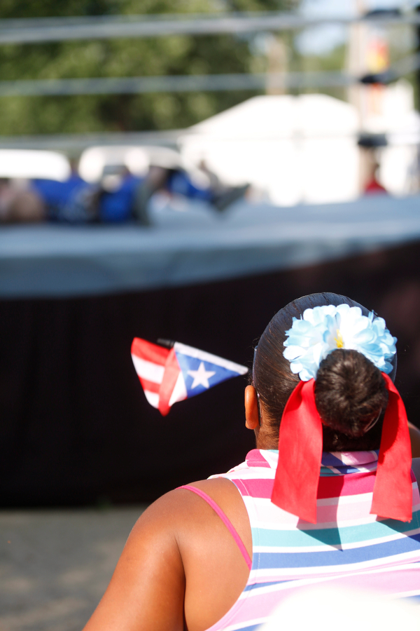 Jodairys Vasquez, 9, of Campbell, waves a Puerto Rican flag while watching wrestling at the Latino Heritage Festival in Campbell on Saturday. EMILY MATTHEWS | THE VINDICATOR