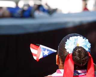 Jodairys Vasquez, 9, of Campbell, waves a Puerto Rican flag while watching wrestling at the Latino Heritage Festival in Campbell on Saturday. EMILY MATTHEWS | THE VINDICATOR