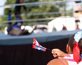 Jodairys Vasquez, 9, of Campbell, waves a Puerto Rican flag while watching wrestling at the Latino Heritage Festival in Campbell on Saturday. EMILY MATTHEWS | THE VINDICATOR