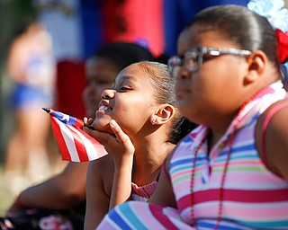 Adriana Holden, 10, of Campbell, holds a Puerto Rican flag while watching wrestling at the Latino Heritage Festival in Campbell on Saturday. EMILY MATTHEWS | THE VINDICATOR