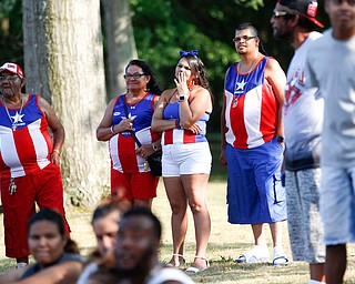 From left, Francisco Laviena, Juana Silva, Alexandra Laviena, and Carmelo Cintron, all of Youngstown and originally from Puerto Rico, watch wrestling at the Latino Heritage Festival in Campbell on Saturday. EMILY MATTHEWS | THE VINDICATOR