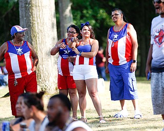 From left, Francisco Laviena, Juana Silva, Alexandra Laviena, and Carmelo Cintron, all of Youngstown and originally from Puerto Rico, watch wrestling at the Latino Heritage Festival in Campbell on Saturday. EMILY MATTHEWS | THE VINDICATOR