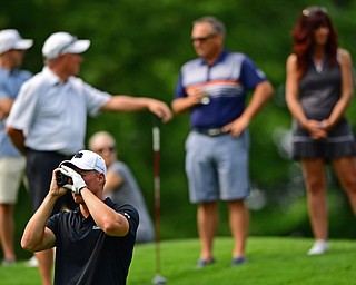 POLAND, OHIO - AUGUST 19, 2018: Scotty Jones uses a range finder before his tee shot on the sixth hole during the final round of the Vindy Greatest Golfer, Sunday afternoon at the Lake Club. DAVID DERMER | THE VINDICATOR