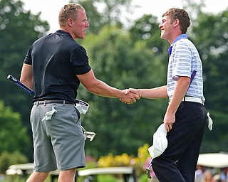 POLAND, OHIO - AUGUST 19, 2018: Scotty Jones, left, shakes hands with Joey Cilone after the completion of their round, Sunday afternoon at the Lake Club. DAVID DERMER | THE VINDICATOR