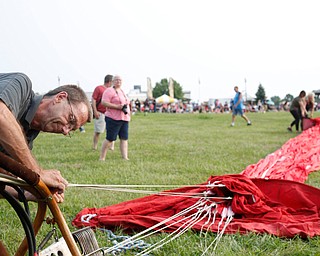 Allan Caddell, of Akron, gets a hot balloon ready at the Hot air balloon festival at Mastropietro Winery on Sunday..