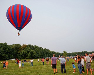 People watch as a hot air balloon takes flight at the Hot air balloon festival at Mastropietro Winery on Sunday.