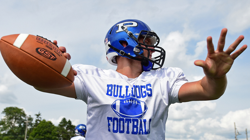 Cole Kosco looks for a receiver during a Monday practice for the Poland Seminary High School Bulldogs. The Bulldogs open their 2018 season at Marlington.