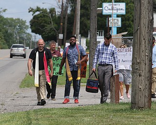  ROBERT K.YOSAY  | THE VINDICATOR..In the spirit of the afternoon, Akron-Canton area residents John Beaty, Austin Miller, Dustin White, James Talbert and JR Rozco prepared for their arrest with a song...After three hours of protest chants, the five clergy members stood at the entrance of the Northeast Ohio Correctional Center on Youngstown-Hubbard Road on Monday with their arms around each other and sang ÒNearer, My God, To TheeÓ Ð the hymn associated with the sinking of the Titanic....-30-