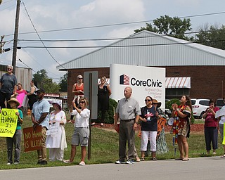  ROBERT K.YOSAY  | THE VINDICATOR..In the spirit of the afternoon, Akron-Canton area residents John Beaty, Austin Miller, Dustin White, James Talbert and JR Rozco prepared for their arrest with a song...After three hours of protest chants, the five clergy members stood at the entrance of the Northeast Ohio Correctional Center on Youngstown-Hubbard Road on Monday with their arms around each other and sang ÒNearer, My God, To TheeÓ Ð the hymn associated with the sinking of the Titanic....-30-