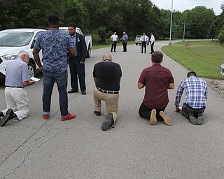  ROBERT K.YOSAY  | THE VINDICATOR..In the spirit of the afternoon, Akron-Canton area residents John Beaty, Austin Miller, Dustin White, James Talbert and JR Rozco prepared for their arrest with a song...After three hours of protest chants, the five clergy members stood at the entrance of the Northeast Ohio Correctional Center on Youngstown-Hubbard Road on Monday with their arms around each other and sang ÒNearer, My God, To TheeÓ Ð the hymn associated with the sinking of the Titanic....-30-