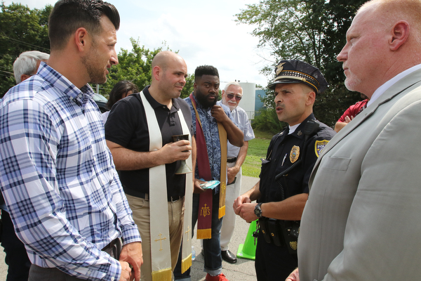  ROBERT K.YOSAY  | THE VINDICATOR..In the spirit of the afternoon, Akron-Canton area residents John Beaty, Austin Miller, Dustin White, James Talbert and JR Rozco prepared for their arrest with a song...After three hours of protest chants, the five clergy members stood at the entrance of the Northeast Ohio Correctional Center on Youngstown-Hubbard Road on Monday with their arms around each other and sang ÒNearer, My God, To TheeÓ Ð the hymn associated with the sinking of the Titanic....-30-