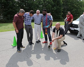  ROBERT K.YOSAY  | THE VINDICATOR..In the spirit of the afternoon, Akron-Canton area residents John Beaty, Austin Miller, Dustin White, James Talbert and JR Rozco prepared for their arrest with a song...After three hours of protest chants, the five clergy members stood at the entrance of the Northeast Ohio Correctional Center on Youngstown-Hubbard Road on Monday with their arms around each other and sang ÒNearer, My God, To TheeÓ Ð the hymn associated with the sinking of the Titanic....-30-