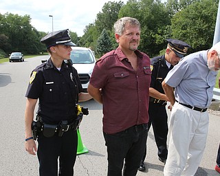  ROBERT K.YOSAY  | THE VINDICATOR..In the spirit of the afternoon, Akron-Canton area residents John Beaty, Austin Miller, Dustin White, James Talbert and JR Rozco prepared for their arrest with a song...After three hours of protest chants, the five clergy members stood at the entrance of the Northeast Ohio Correctional Center on Youngstown-Hubbard Road on Monday with their arms around each other and sang ÒNearer, My God, To TheeÓ Ð the hymn associated with the sinking of the Titanic....-30-