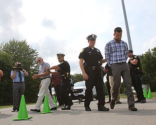  ROBERT K.YOSAY  | THE VINDICATOR..In the spirit of the afternoon, Akron-Canton area residents John Beaty, Austin Miller, Dustin White, James Talbert and JR Rozco prepared for their arrest with a song...After three hours of protest chants, the five clergy members stood at the entrance of the Northeast Ohio Correctional Center on Youngstown-Hubbard Road on Monday with their arms around each other and sang ÒNearer, My God, To TheeÓ Ð the hymn associated with the sinking of the Titanic....-30-