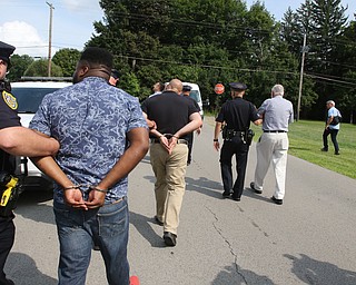  ROBERT K.YOSAY  | THE VINDICATOR..In the spirit of the afternoon, Akron-Canton area residents John Beaty, Austin Miller, Dustin White, James Talbert and JR Rozco prepared for their arrest with a song...After three hours of protest chants, the five clergy members stood at the entrance of the Northeast Ohio Correctional Center on Youngstown-Hubbard Road on Monday with their arms around each other and sang ÒNearer, My God, To TheeÓ Ð the hymn associated with the sinking of the Titanic....-30-