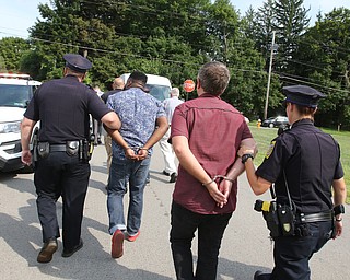  ROBERT K.YOSAY  | THE VINDICATOR..In the spirit of the afternoon, Akron-Canton area residents John Beaty, Austin Miller, Dustin White, James Talbert and JR Rozco prepared for their arrest with a song...After three hours of protest chants, the five clergy members stood at the entrance of the Northeast Ohio Correctional Center on Youngstown-Hubbard Road on Monday with their arms around each other and sang ÒNearer, My God, To TheeÓ Ð the hymn associated with the sinking of the Titanic....-30-