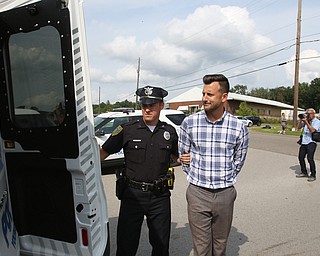  ROBERT K.YOSAY  | THE VINDICATOR..In the spirit of the afternoon, Akron-Canton area residents John Beaty, Austin Miller, Dustin White, James Talbert and JR Rozco prepared for their arrest with a song...After three hours of protest chants, the five clergy members stood at the entrance of the Northeast Ohio Correctional Center on Youngstown-Hubbard Road on Monday with their arms around each other and sang ÒNearer, My God, To TheeÓ Ð the hymn associated with the sinking of the Titanic....-30-