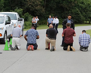  ROBERT K.YOSAY  | THE VINDICATOR..In the spirit of the afternoon, Akron-Canton area residents John Beaty, Austin Miller, Dustin White, James Talbert and JR Rozco prepared for their arrest with a song...After three hours of protest chants, the five clergy members stood at the entrance of the Northeast Ohio Correctional Center on Youngstown-Hubbard Road on Monday with their arms around each other and sang ÒNearer, My God, To TheeÓ Ð the hymn associated with the sinking of the Titanic....-30-