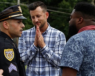  ROBERT K.YOSAY  | THE VINDICATOR..In the spirit of the afternoon, Akron-Canton area residents John Beaty, Austin Miller, Dustin White, James Talbert and JR Rozco prepared for their arrest with a song...After three hours of protest chants, the five clergy members stood at the entrance of the Northeast Ohio Correctional Center on Youngstown-Hubbard Road on Monday with their arms around each other and sang ÒNearer, My God, To TheeÓ Ð the hymn associated with the sinking of the Titanic....-30-