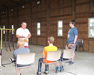 Neighbors | Jessica Harker .Instructor Steve Adams explained various techniques to students before they began practicing on July 24 at the annual archery camp at Mill Creek MetroParks Farms.