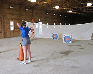 Neighbors | Jessica Harker .Student Marissa Coroy demonstrated both good and bad follow through technique on July 24 at the annual archery camp at MetroParks Farms.