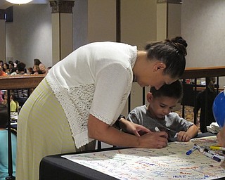 Neighbors | Jessica Harker.Stephanie and Stephen Williams signed a thank you card for Marc Brown at the summer reading programs annual breakfast.
