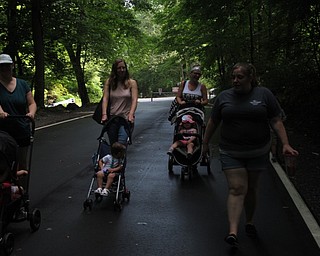 Neighbors | Jessica Harker.Cody Stoll led the group of guardians with their strollers through Mill Creek Park on July 31 for the Trot With Your Tot event.