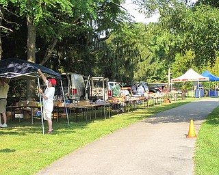 Neighbors | Jessica Harker.Vendors lined the sidewalk, setting up a flea market, on Aug. 5 during the 40th MVOCC car show in Boardman Park.