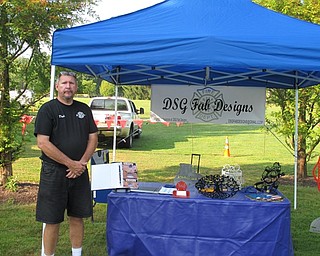 Neighbors | Jessica Harker.Dale Gaus stood in front of his stand at the 40th annual MVOCC car show on Aug. 5 at Boardman Park.