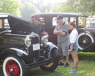 Neighbors | Jessica Harker.Car owners and spectors discussed the cars on display on Aug. 5 at the Boardman Park.
