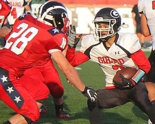 William D. Leiws The Vindicator  Girard's Morgan Clardy(2) is stopped by Niles Robbie Savin(28) during 8-23-18 action at Niles.