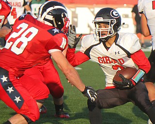 William D. Leiws The Vindicator  Girard's Morgan Clardy (2) is stopped by Niles's Robbie Savin (28) during the game at Niles on Aug. 23, 2018.